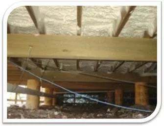 Fiberglass batts installed in a crawl space.